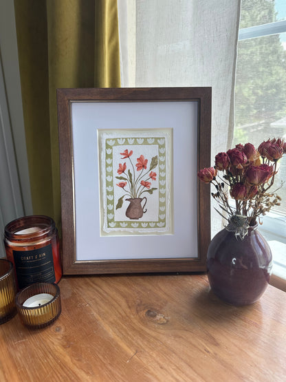 Red flowers in brown vase, framed
